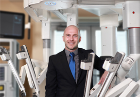 Dr. McEwen's Posing with da Vinci Surgical Robot